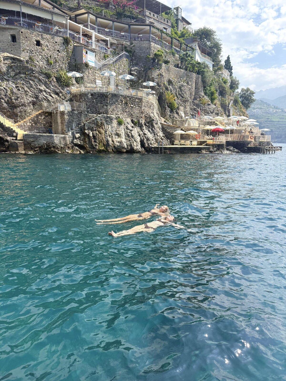 Floating in the turquoise water below the Amalfi cliffs