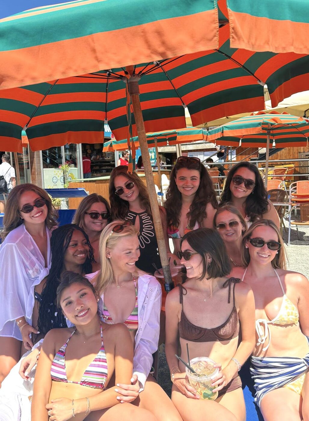 The group together under the beach umbrella