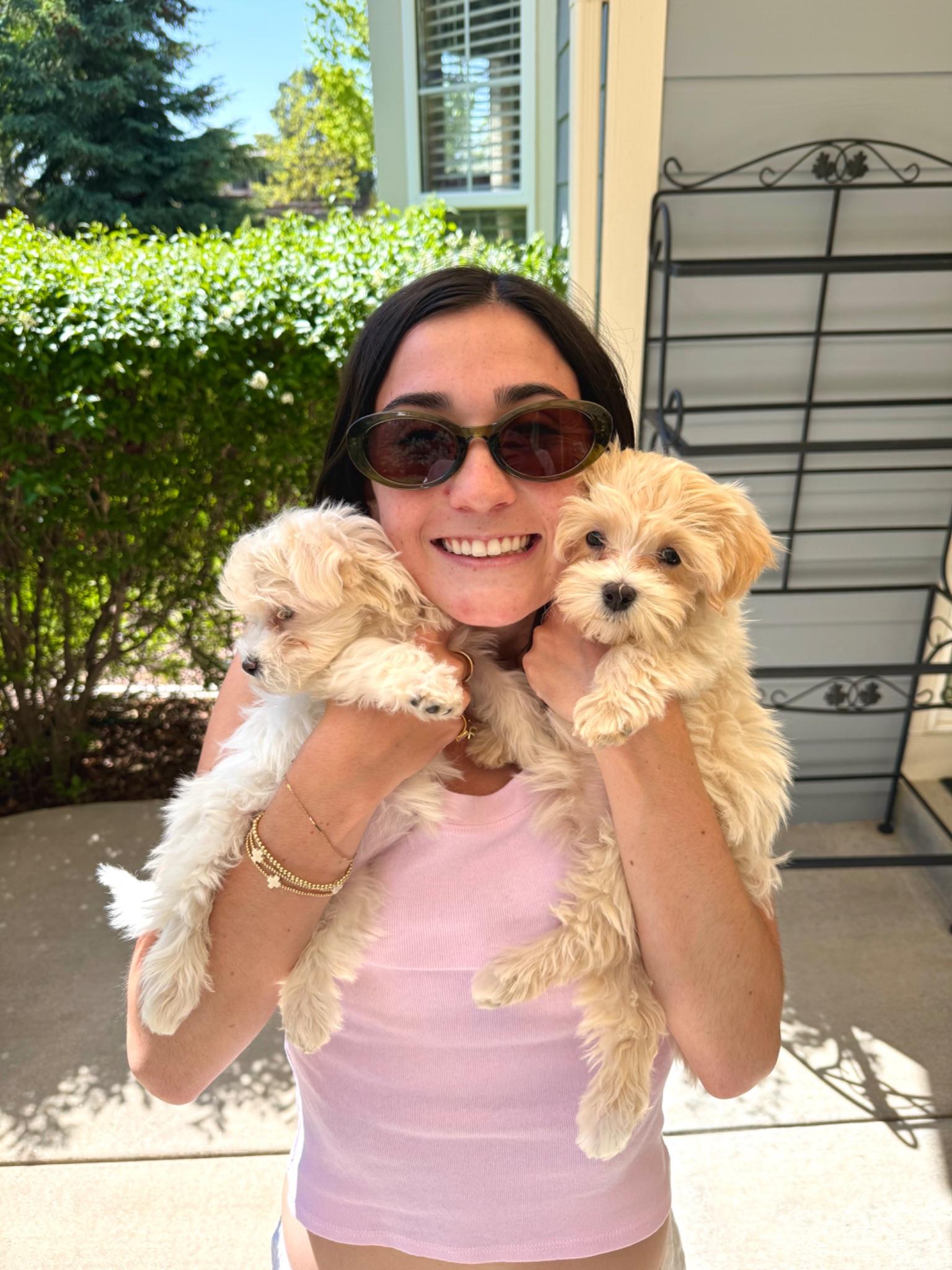 Holding the new puppies, Lucy and Bella