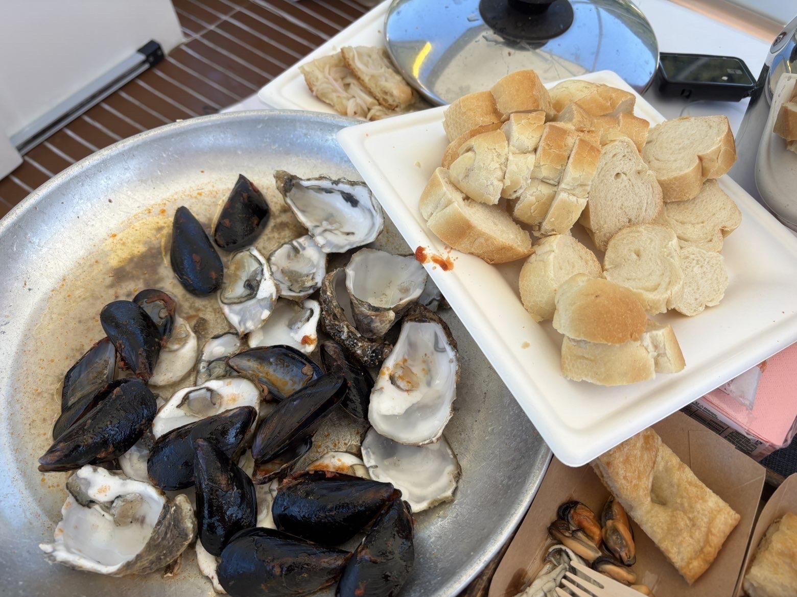 Oysters served alongside a plate of white bread