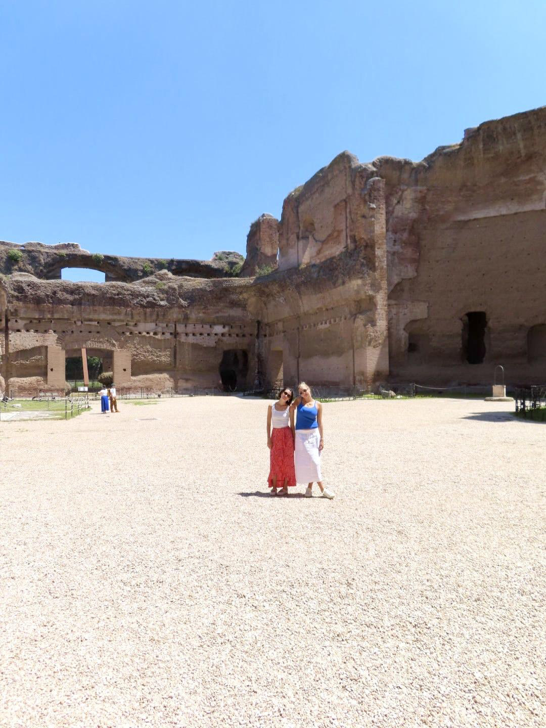 Standing together in the courtyard of the Ancient Roman Bathhouse ruins