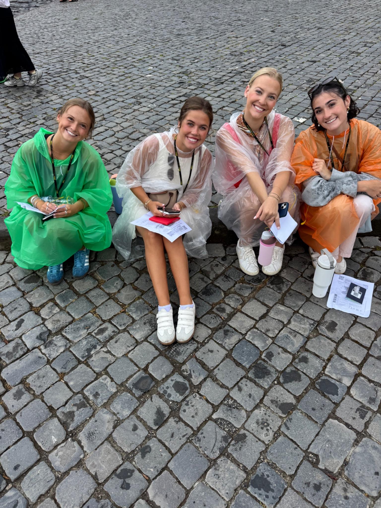 Sitting on the wet cobblestones in our ponchos